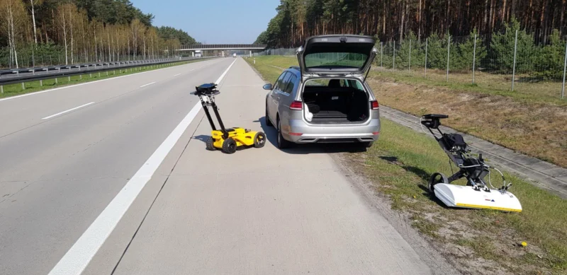 Yellow Leica DS2000 during survey work beside the A18 motorway, with another survey device nearby
